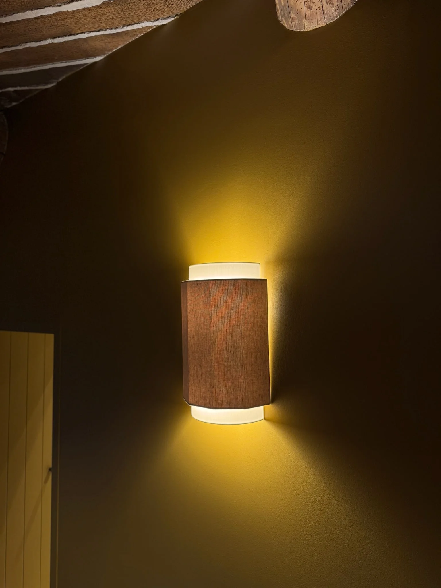 Wall light on the bronze wall — Petite Fontaine