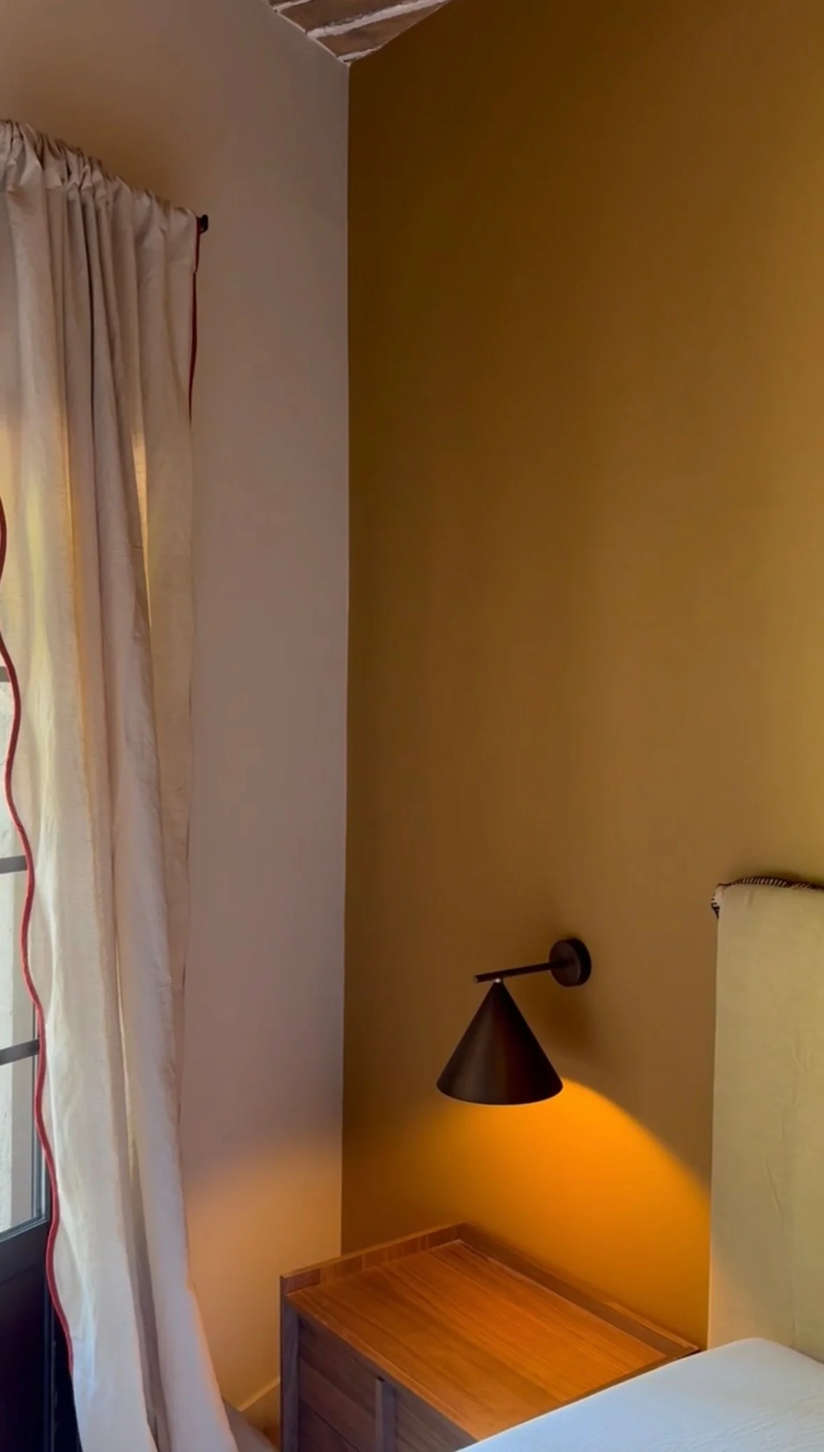 Bedside reading light and linen curtain — Petite Fontaine